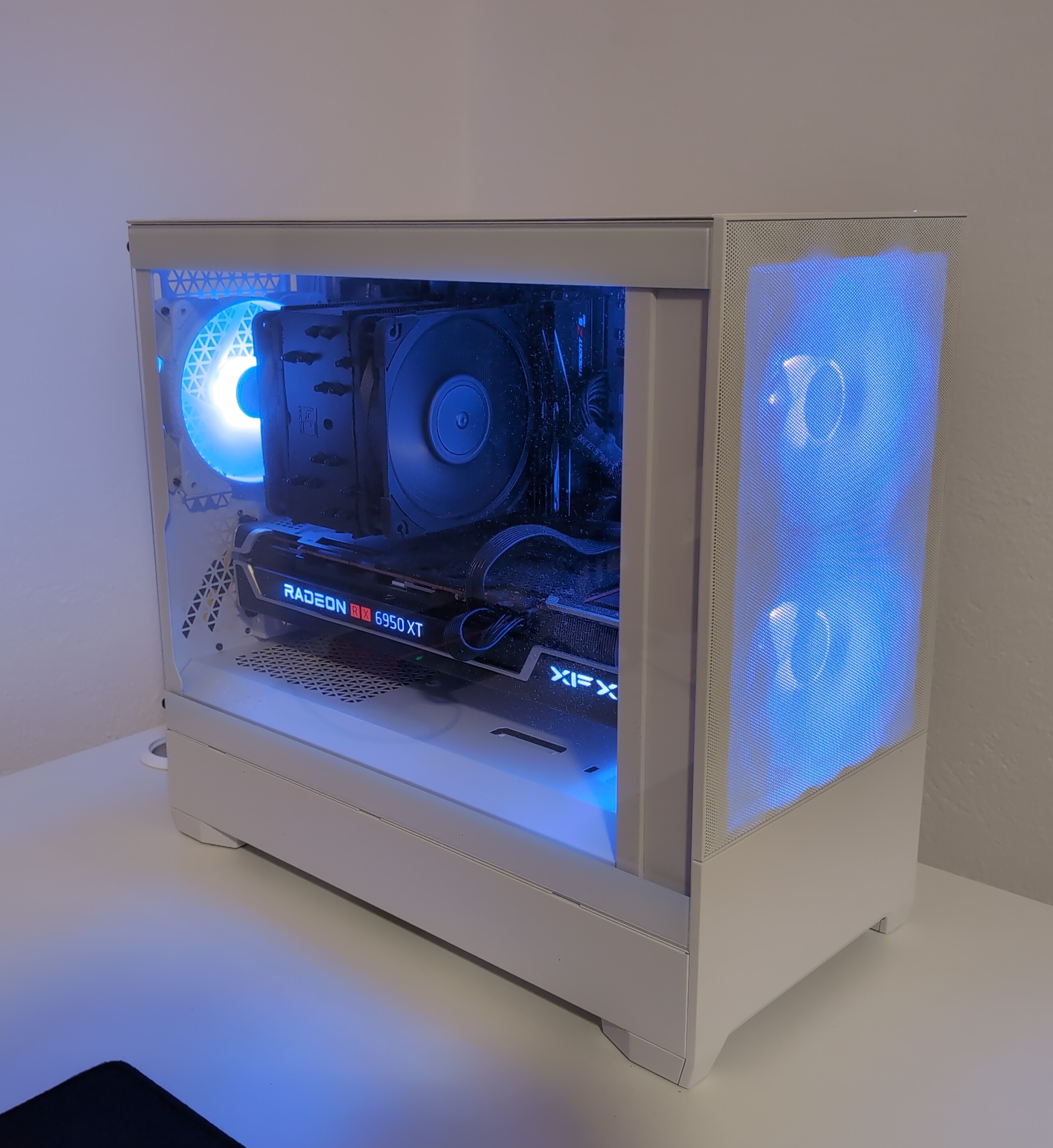 Clean white PC case with tempered glass side panel, illuminated by white LED lighting